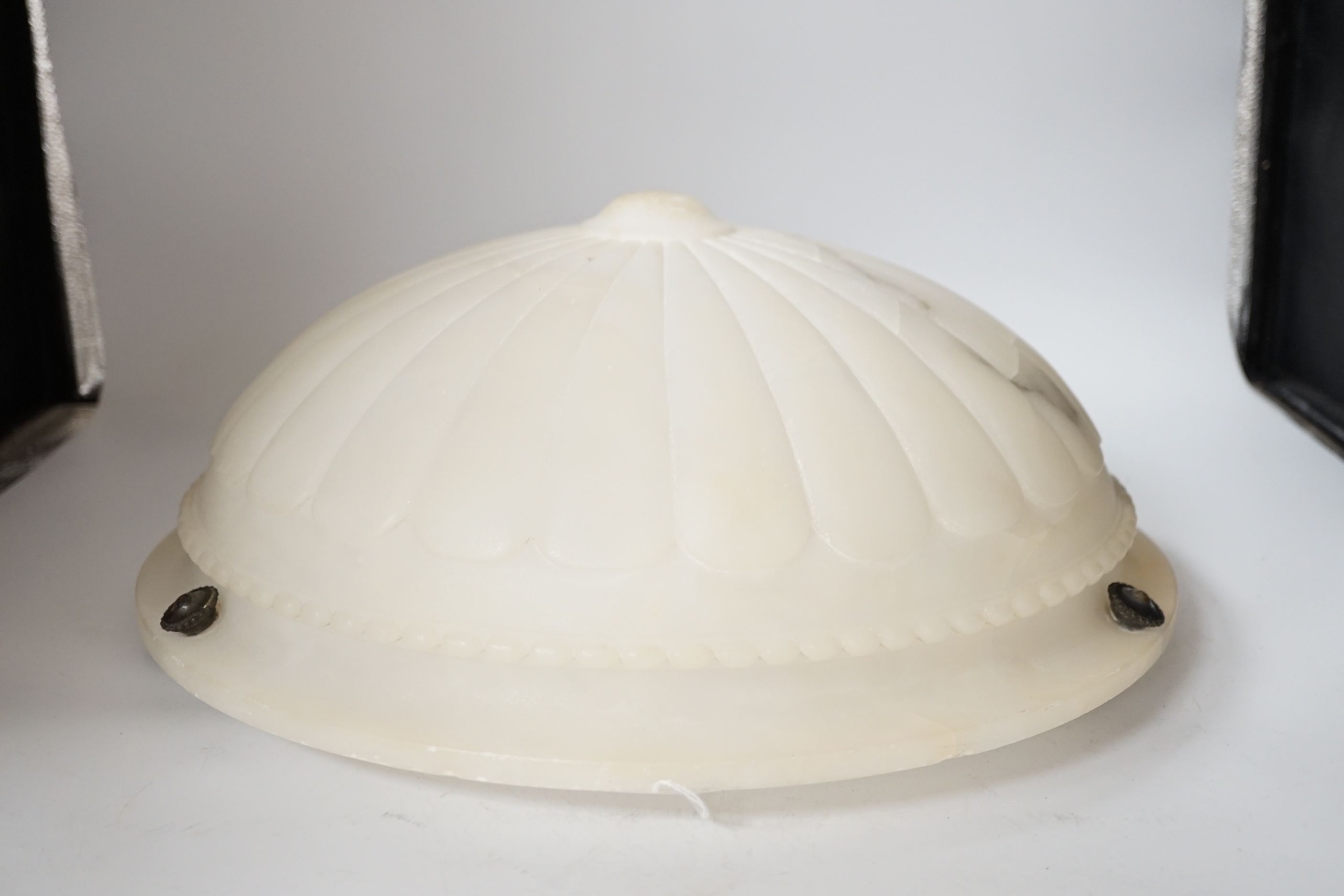 A carved alabaster ceiling shade, with three chains, diameter 40cm